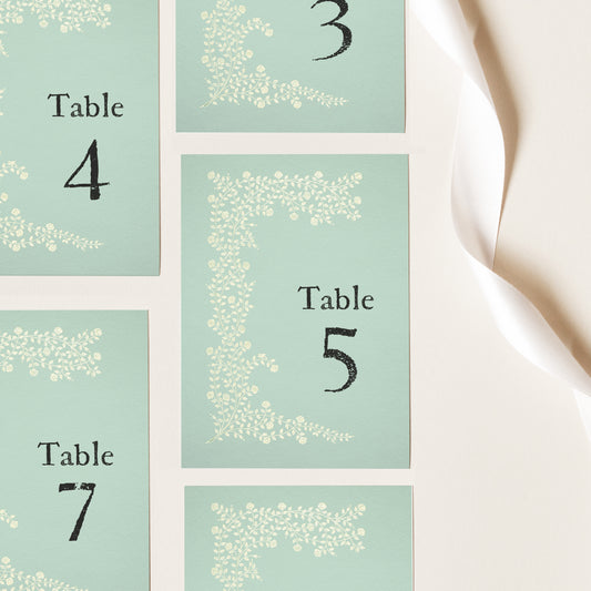 Whimsical table numbers in sage green for garden wedding or party