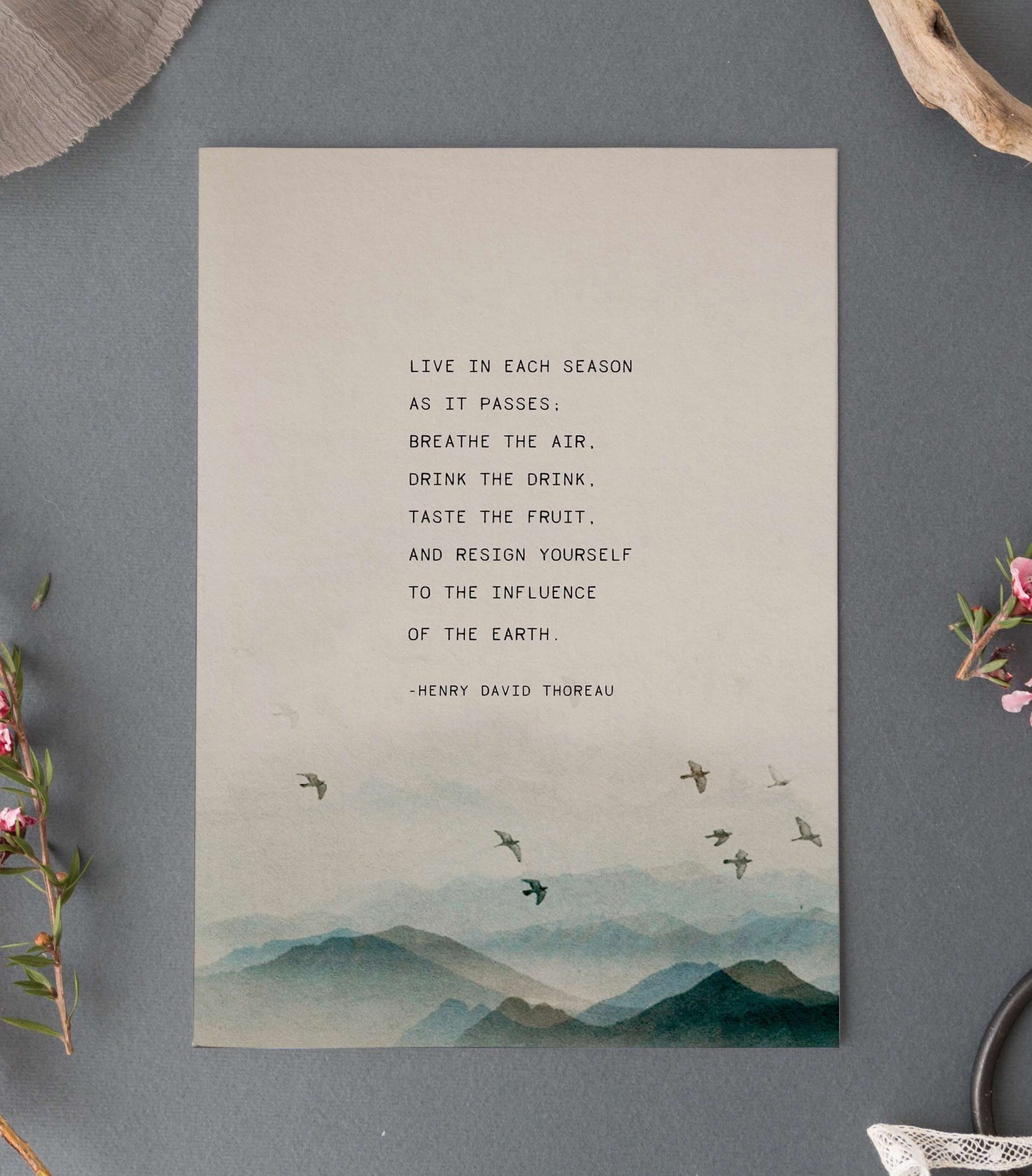 Henry David Thoreau Quote set on a watercolor image of mountains and birds
