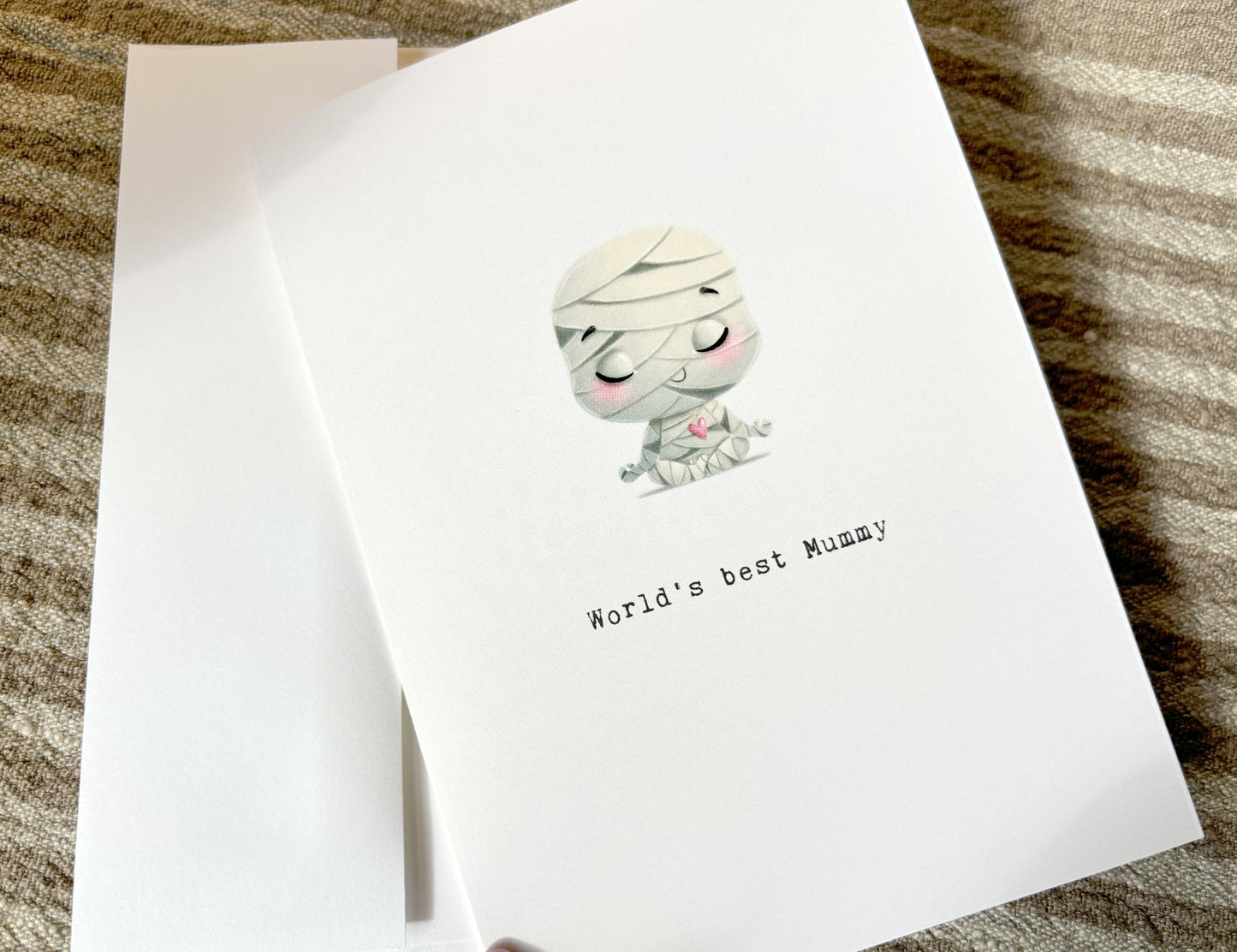 Mmother's day card with an illustration of a cute mummy and it say's "world's best mummy" on the outside